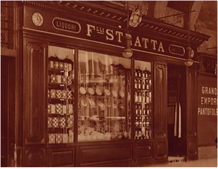 La bottega dei Fratelli Stratta in una fotografia d'epoca color seppia: le vetrine e l'insegna